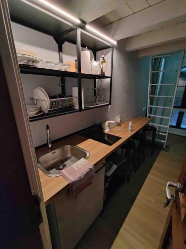a kitchen with a sink and a table with chairs at NIC Lake House in Sulzano