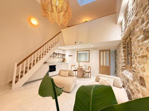 a living room with a couch and a table at Cottage in Pontivy