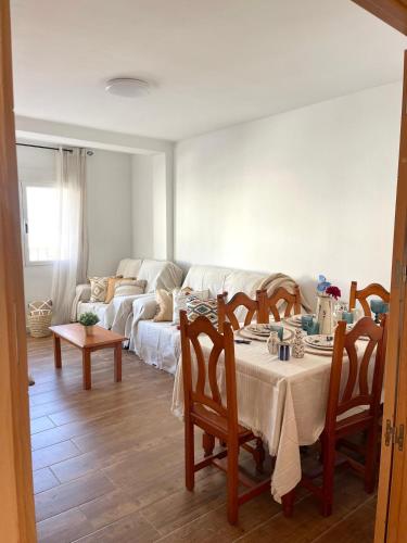 a living room with a table and a couch at El Alfarero Níjar in Níjar