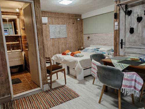 a bedroom with a bed and a table and chairs at Barbara Ház in Hévíz