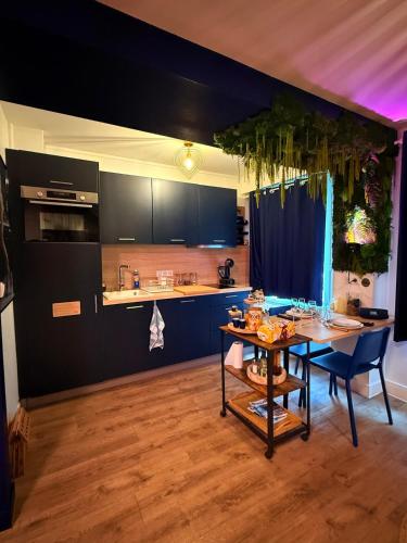 a kitchen with a table and a dining room at Evasion à deux - Spa privatif in Beaugency