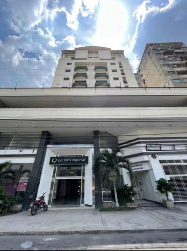 a building with a motorcycle parked in front of it at Torre Imperial Apartamento in Maracay