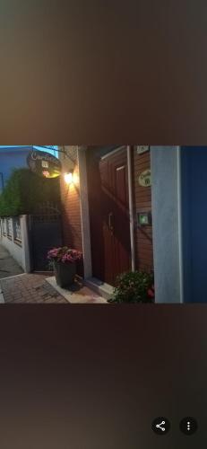 a view of a building with a door and flowers at B&B Carlotta in Montesilvano