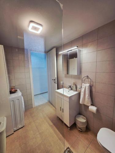 a bathroom with a sink and a toilet and a shower at Hidden Gem 2BR Apartment | Loutraki in Loutraki