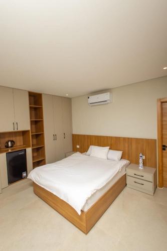 a bedroom with a large white bed in it at Family Nexus Hotel - Carefree in Hurghada