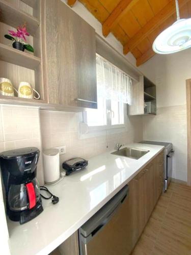 a kitchen with a sink and a counter top at Theo apartment with Balcony in Marathias