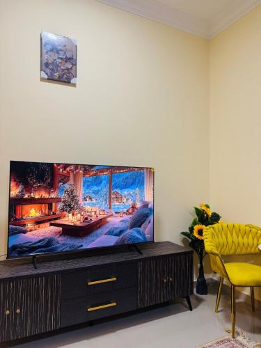 a living room with a large flat screen tv at Quiet area studio, fully furnished and ready now u in Abu Dhabi