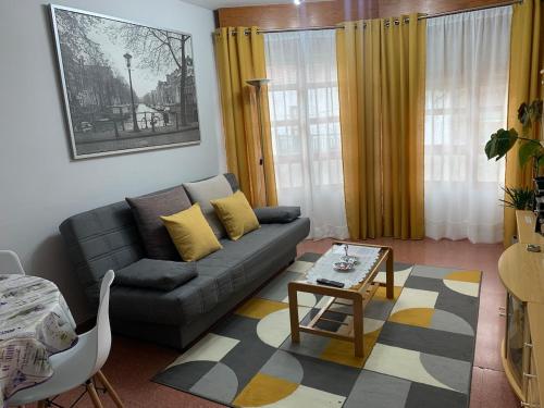 a living room with a couch and a table at La casita de Lukas in Sabero