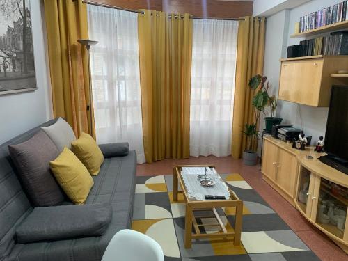 a living room with a couch and a coffee table at La casita de Lukas in Sabero