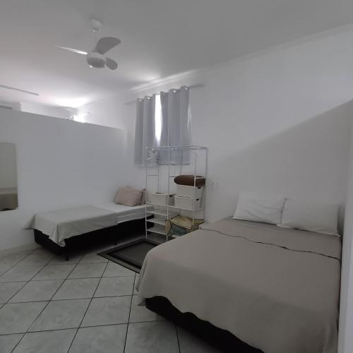 a bedroom with two beds and a ceiling fan at Aconchego GG in Indaiatuba