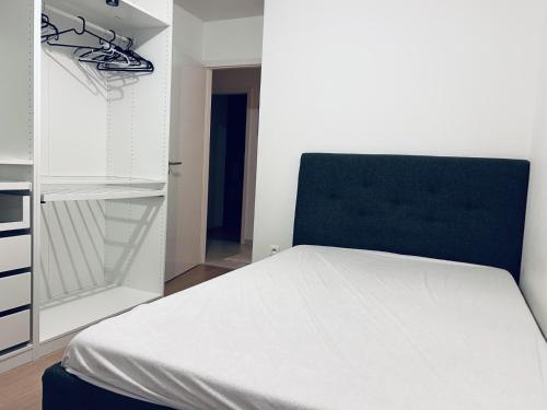 a bedroom with a white bed and a closet at Cocon family in Strasbourg