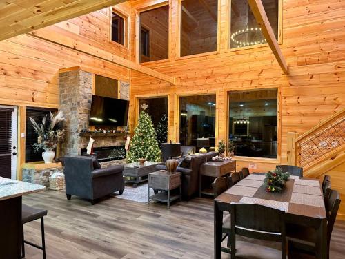 a living room with wooden ceilings and a fireplace at Luxury Cabin with Hot Tub, Game Room and Movie Theater in Sevierville