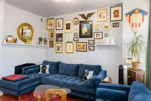 a living room with a blue couch and pictures on the wall at Cap Hill Row 2 Bedrooms, Walk to Sights, Parking in Washington, D.C.