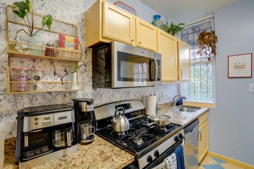a kitchen with a stove and a microwave at Cap Hill Row 2 Bedrooms, Walk to Sights, Parking in Washington, D.C.