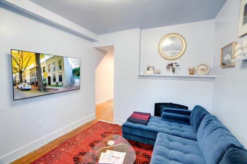 a living room with a blue couch and a table at Cap Hill Row 2 Bedrooms, Walk to Sights, Parking in Washington, D.C.