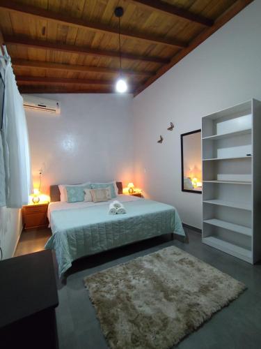 Pousada do Betão في غواردا دو إمباو: غرفة نوم بها سرير كبير وسجادة