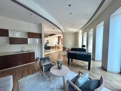 a living room with a pool table and a piano at Private Sea View Room in 3BR Downtown Apartment Direct Mall & Metro Access in Dubai
