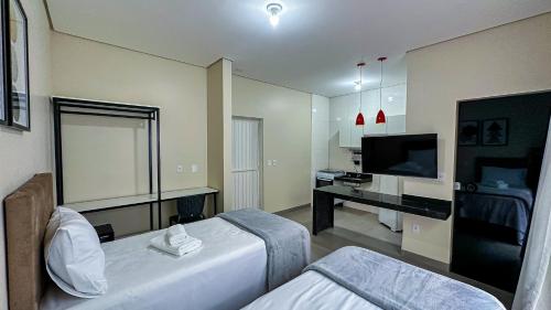 una camera d'albergo con un letto e una televisione di Flat & Hotel Executive a Confresa