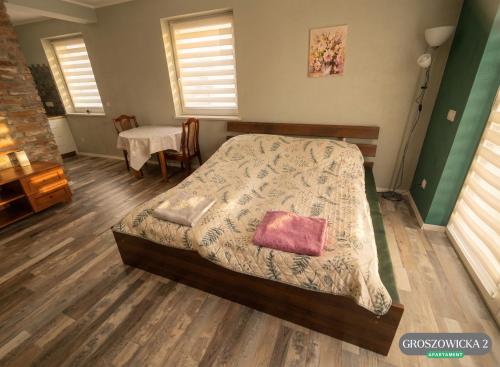a bedroom with a bed with a pillow on it at Przytulne i ciepłe mieszkanie w spokojnej dzielnicy Opola in Opole