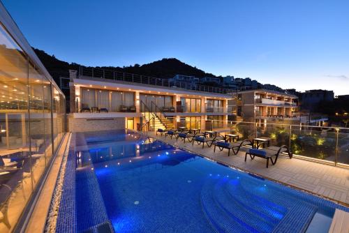 a building with a swimming pool at night at Spektr Boutique Hotel Yalikavak in Yalıkavak