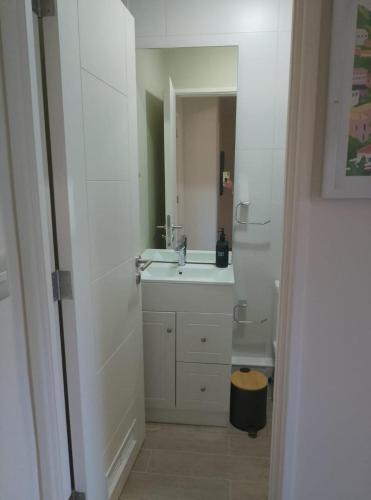 a white bathroom with a sink and a toilet at Vive Pucón in Pucón