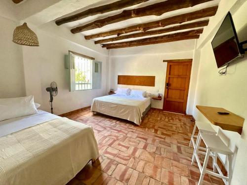 Ένα ή περισσότερα κρεβάτια σε δωμάτιο στο Casa Mónica Barichara