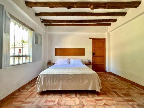 Ένα ή περισσότερα κρεβάτια σε δωμάτιο στο Casa Mónica Barichara