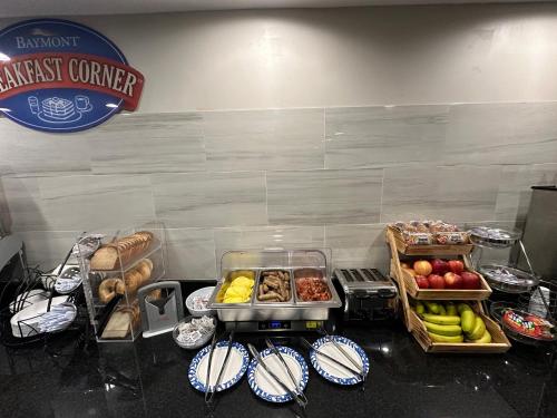 a breakfast counter with different types of fruits and vegetables at Baymont by Wyndham Indianapolis South in Indianapolis