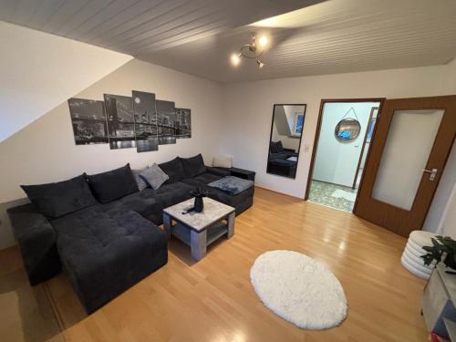 a living room with a couch and a table at Wohnung in Würzburg Rimpar I Netflix & TV I Kaffee I Tee I Brettspiele in Rimpar