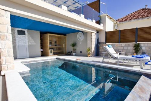 a swimming pool in the backyard of a house at Villa D' Republic Dubrovnik - Infinity Pool & Old Town Views in Dubrovnik