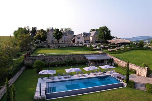 eine Luftansicht eines Anwesens mit Pool in der Unterkunft Les Terrasses de MAJORAC - La Grange in Bozouls