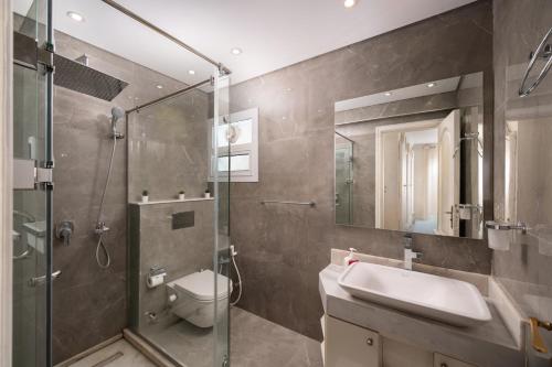 a bathroom with a shower and a toilet and a sink at The White Coconut Stay in Cairo