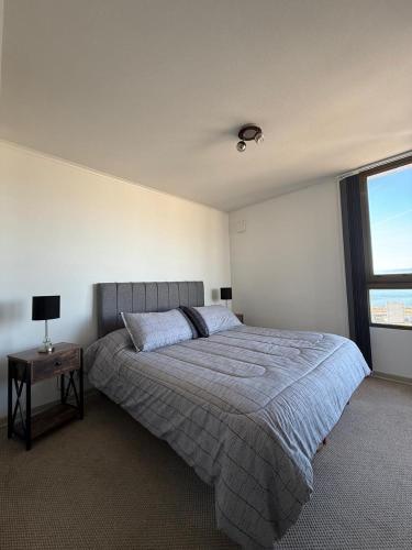 a bedroom with a large bed and a window at alojamiento en coquimbo in Coquimbo