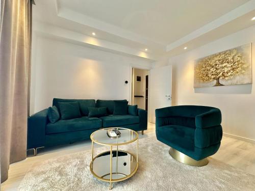 a living room with a blue couch and a table at Aurora Premium Cosmopolis in Tunari