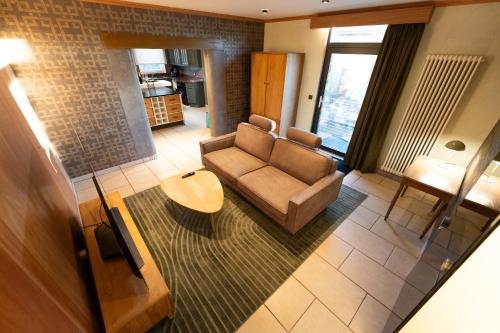 un salon avec un canapé et une table dans l'établissement Les pantoufles dans les étoiles, à Eppeldorf