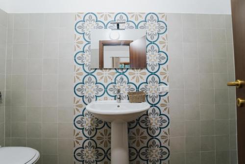 a bathroom with a sink and a toilet at Agriturismo Marzilio in Ficarra