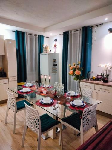 a dining room with a glass table and chairs at Glamorous flat in Mertzwiller in Mertzwiller
