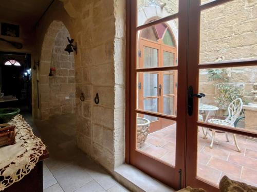 a door leading to a patio with a table at Traditional House of Character - 6 Guests Max in Rabat