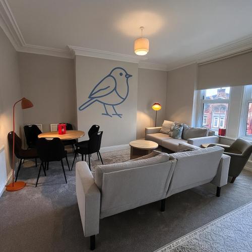 a living room with a couch and a table at The Bluebird Rooms III in Central Station