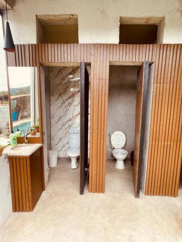 a bathroom with two toilets and a sink at Chácara Com Piscina e Vista das Montanhas in Atibaia