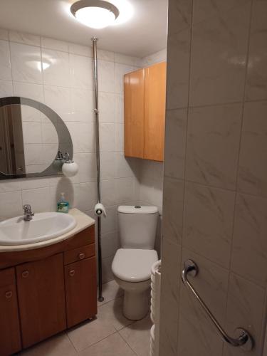 a bathroom with a toilet and a sink and a mirror at Apartament Multik in Tarnów