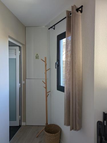 a bathroom with a shower curtain and a window at Monte Gordo Accommodation in Ribeira Brava