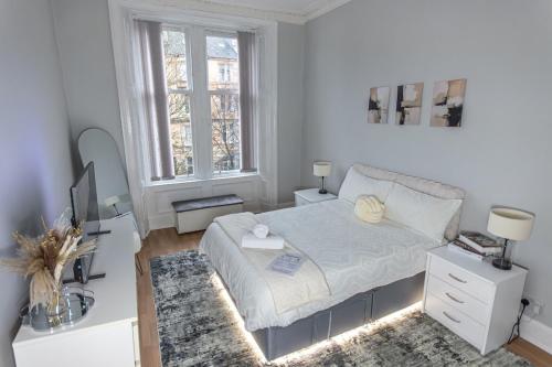 a white bedroom with a bed and a desk at FREE Pool Table Cinema Room TableTennis AirHockey Glasgow City in Glasgow