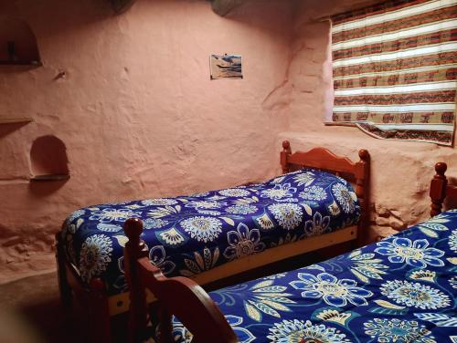 Ένα ή περισσότερα κρεβάτια σε δωμάτιο στο Casa Minerva, construcción de materiales autoctonos