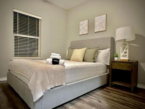 a bedroom with a bed and a lamp and a window at Cozy Quiet LongStayDiscount A plus Location byChoctaw in Durant