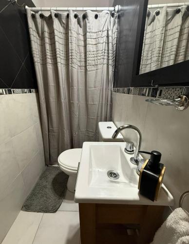 a bathroom with a sink and a toilet and a shower at Merlo ink3 in Merlo