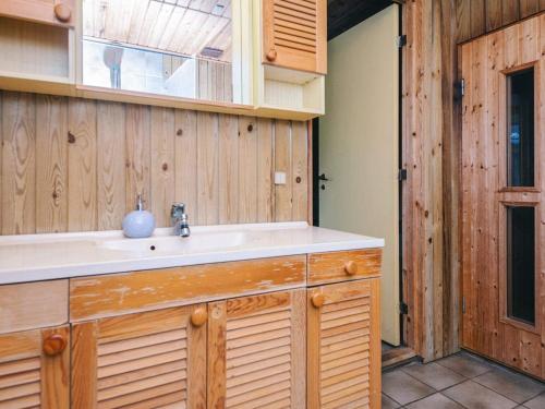 a kitchen with a sink and wooden walls at Luxury Retreat in Blavand - By Traum Ferienwohnungen in Blåvand