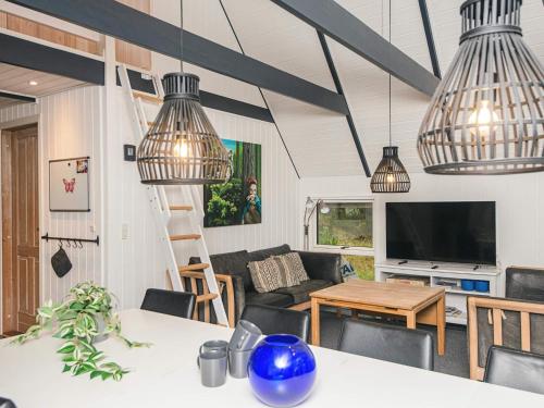 a living room with pendant lights and a table at Luxury Retreat in Blavand in Blåvand
