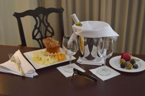 a table with wine glasses and a plate of food at O.Henry Hotel in Greensboro