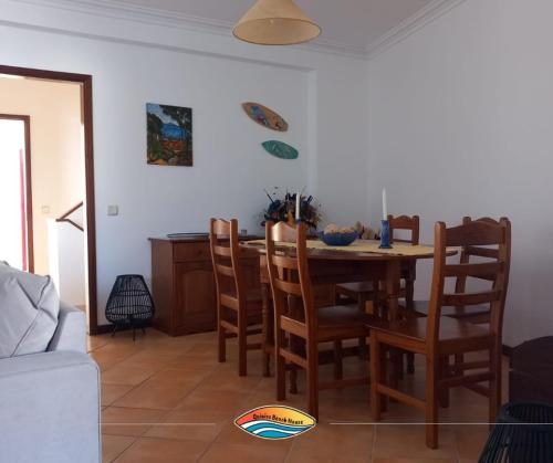 a dining room with a table and chairs at Quiaios Beach House in Quiaios